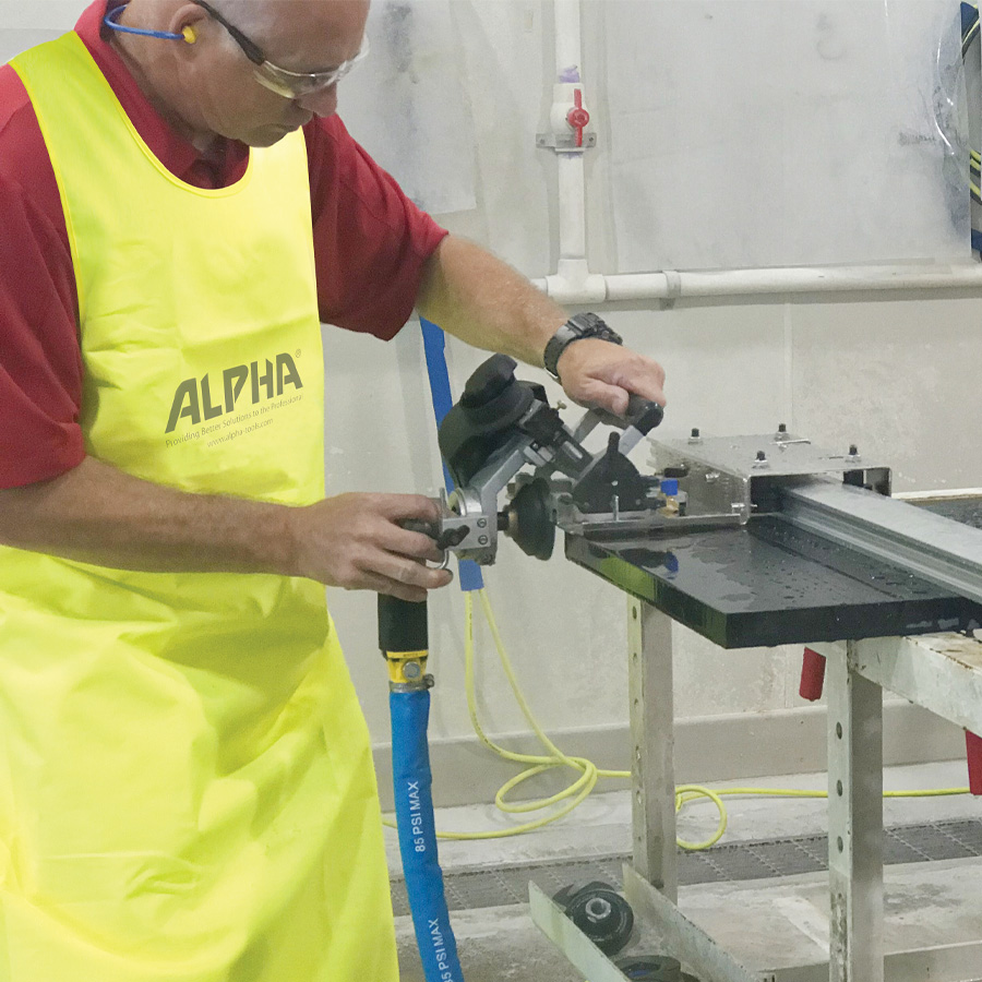 Stonemason with safety googles and apron